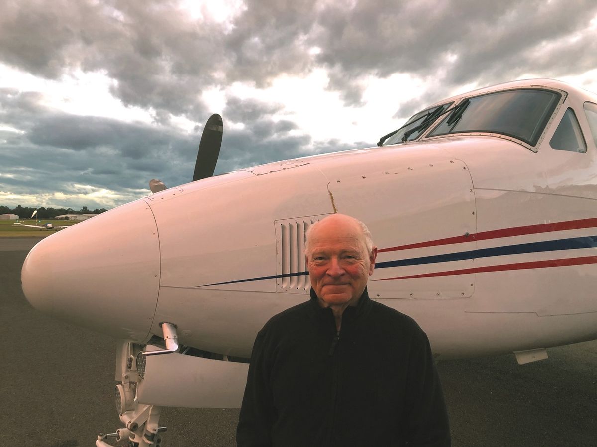 Dr. Richard Rawson standing in front of RFDS plane