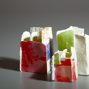 Slab built white porcelain vessels with some surfaces of red, green and blue