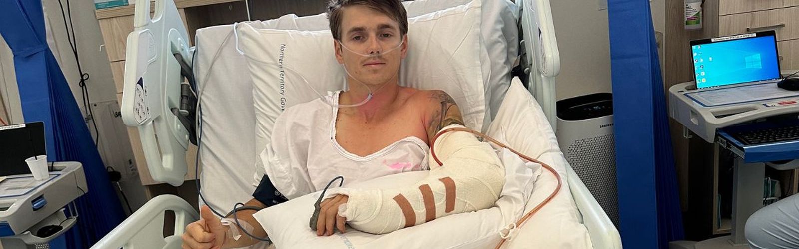 Callum smiling in a hospital bed