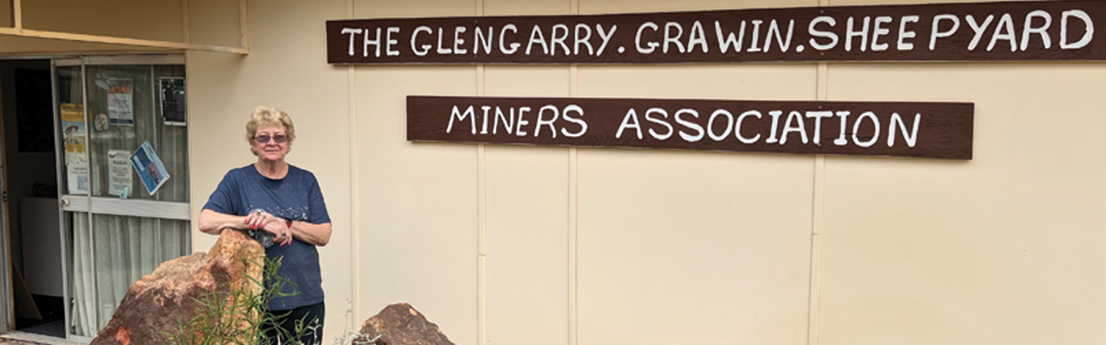 Volunteer Lesley in front of Clinic