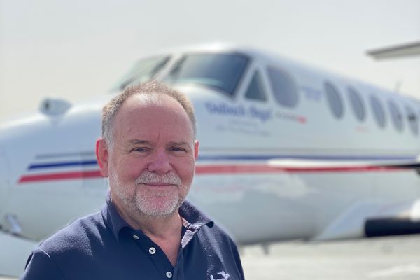 Captain James Williams in front of an RFDS Aircraft