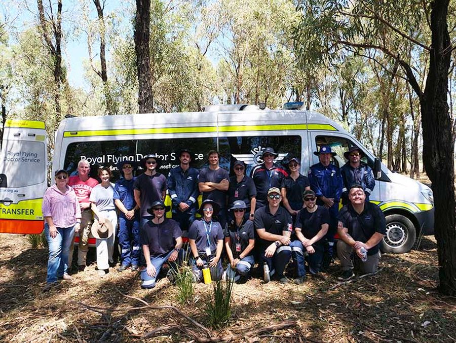 Four students and two nurses standing next to RFDS Mobile Education Unit at Dubbo base