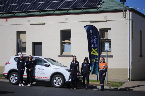 RFDS and Amplitude stand around an RFDS car in Orbost