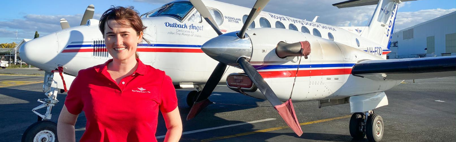 Midwifery scholarship winner Megan Wood in front of an RFDS aircraft