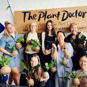 A group of people holding plants
