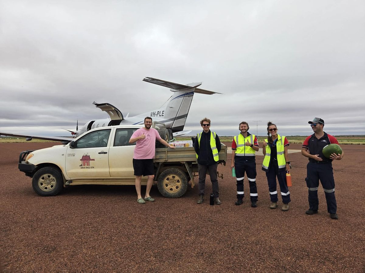 RFDS crew assisting with food drop