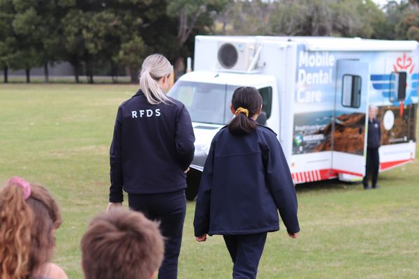 RFDS Tasmania Dental Coordinator with student walking towards mobile dental van.