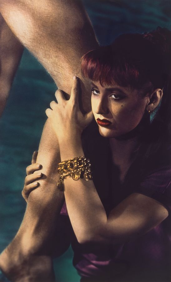 photograph of woman holding man's leg