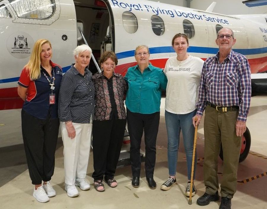 Ancestors smiling in front of a PC-12.