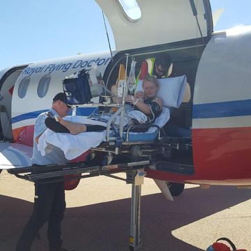Archie and Laura being loaded into RFDS aircraft