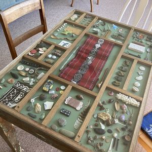 A collection of objects under a glass coffee table top