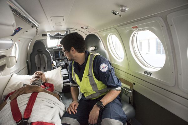 patient in stretcher in aircraft