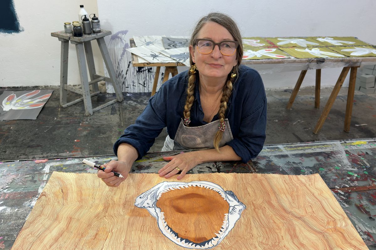 A photo of Helen Britton in her studio working on an artwork