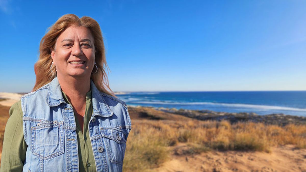 Carol smiling in front of a PC-12.