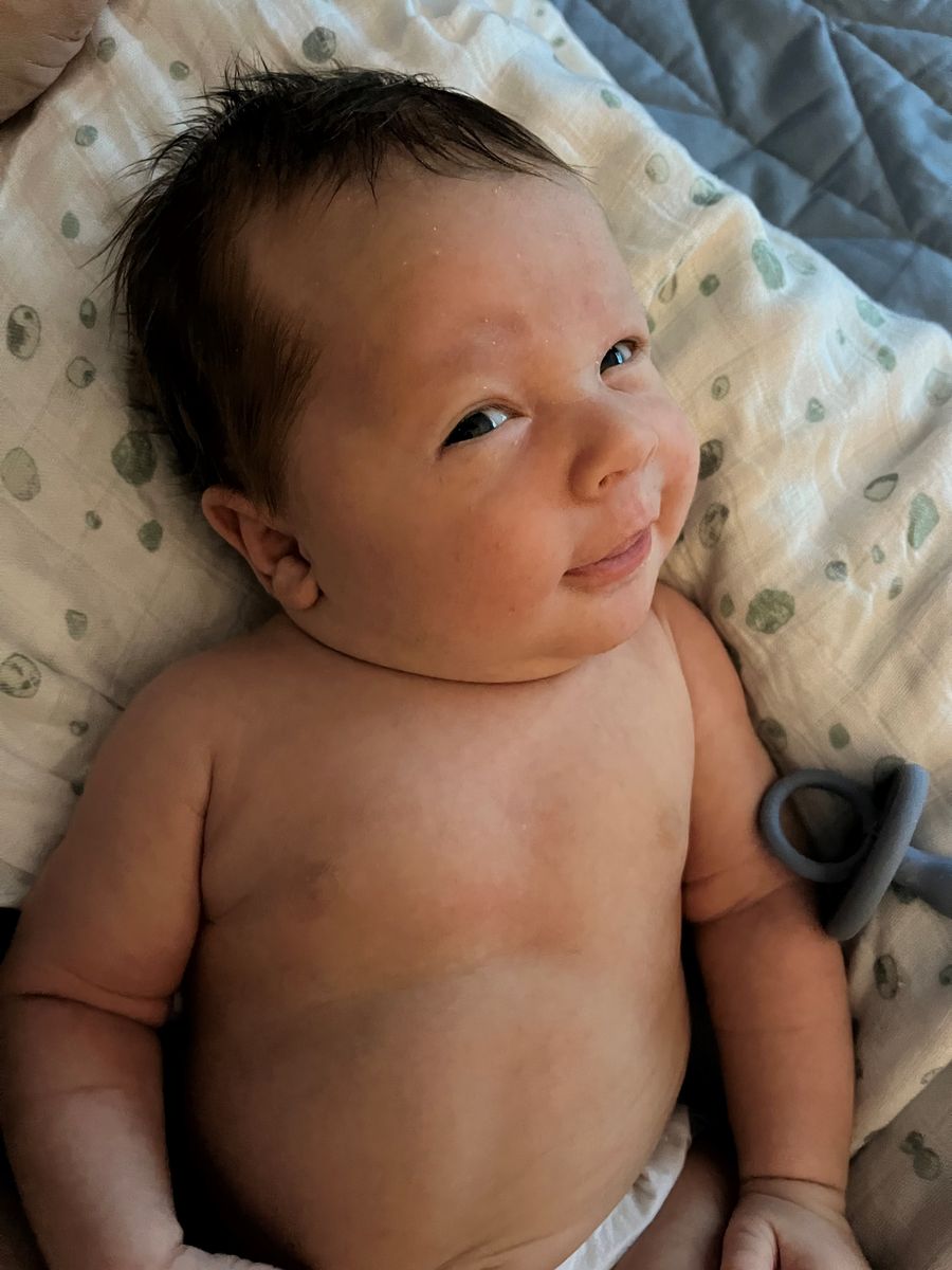 Baby Lucas giving a cheeky smile.
