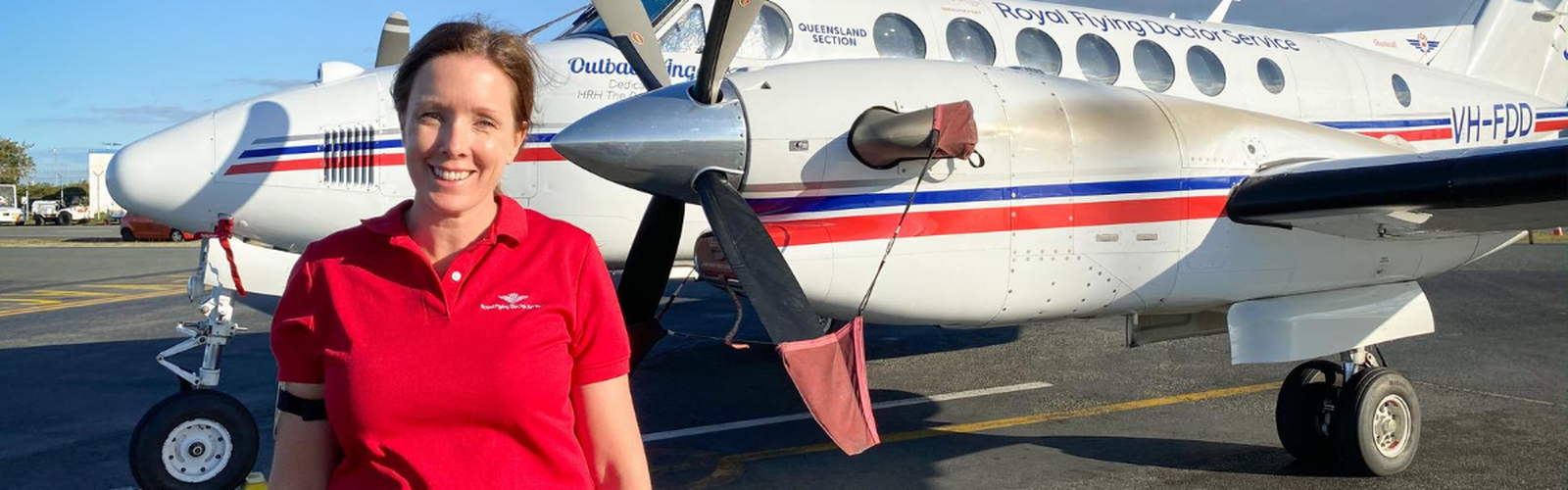 Elizabeth Ferrier standing in front of an RFDS plane