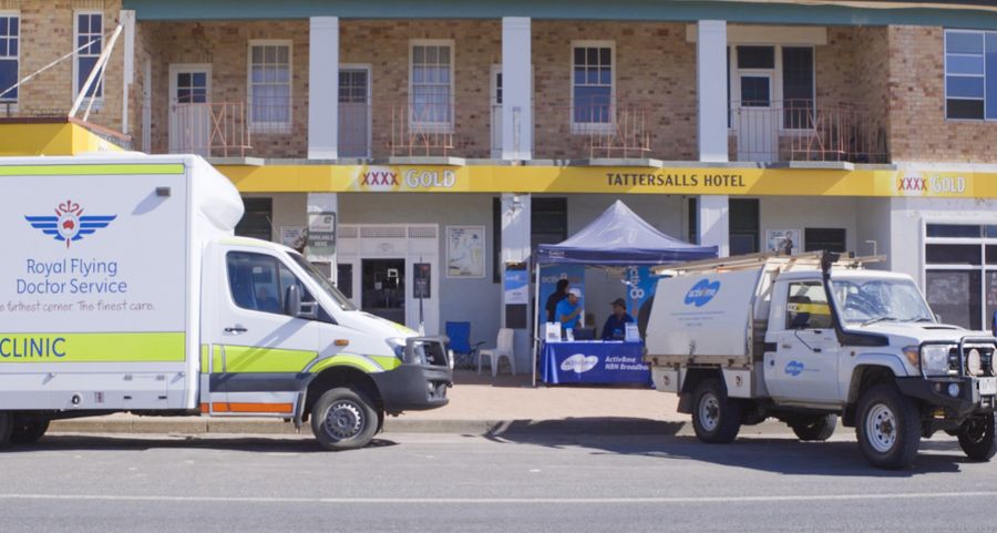 RFDS Dental Van and Activ8me truck parked out Pub in Collarenebri