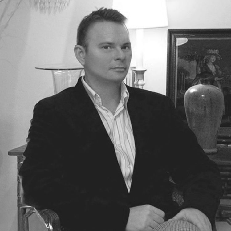 Distinguished man sitting in chair with fancy light behind him