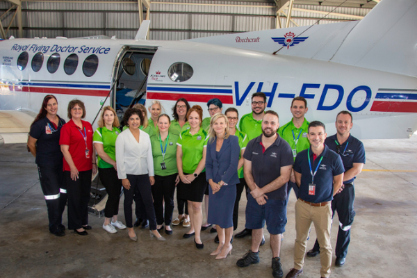 Ergon Energy Retail and RFDS staff in front of aircraft