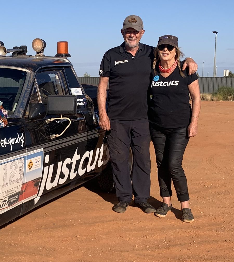 Jen with Dennis in front of Just Cuts trek car
