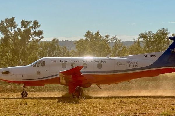 PC-12 taking off from a paddock.