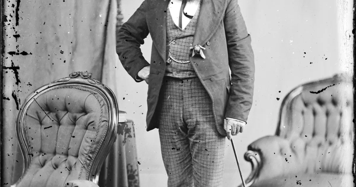 Studio portrait of bearded man, cane in hand - AGSA Collection