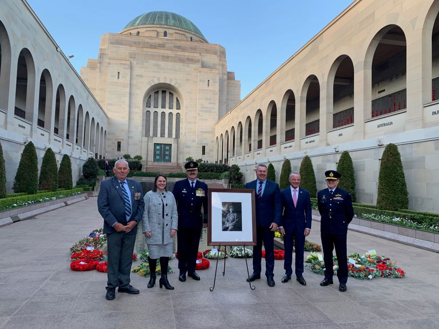 Peel Family gathered around the portrait of Clifford Peel at the AWM