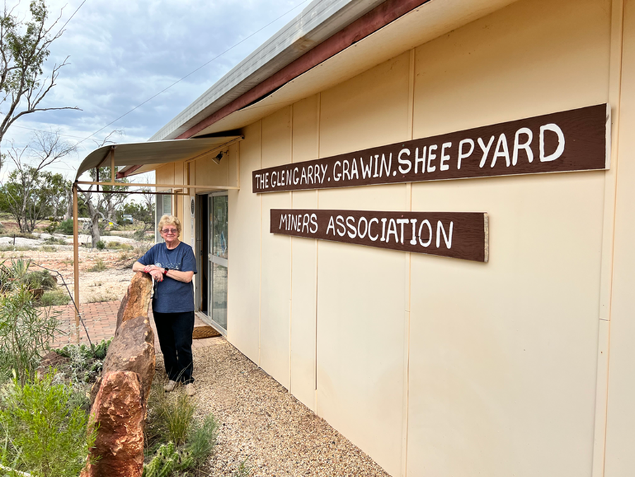 Volunteer Lesley in front of Clinic