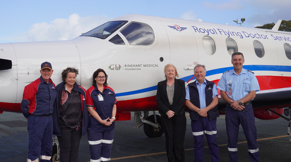 RFDS staff with a PC-12 bearing the Rinehart Medical Foundation logo