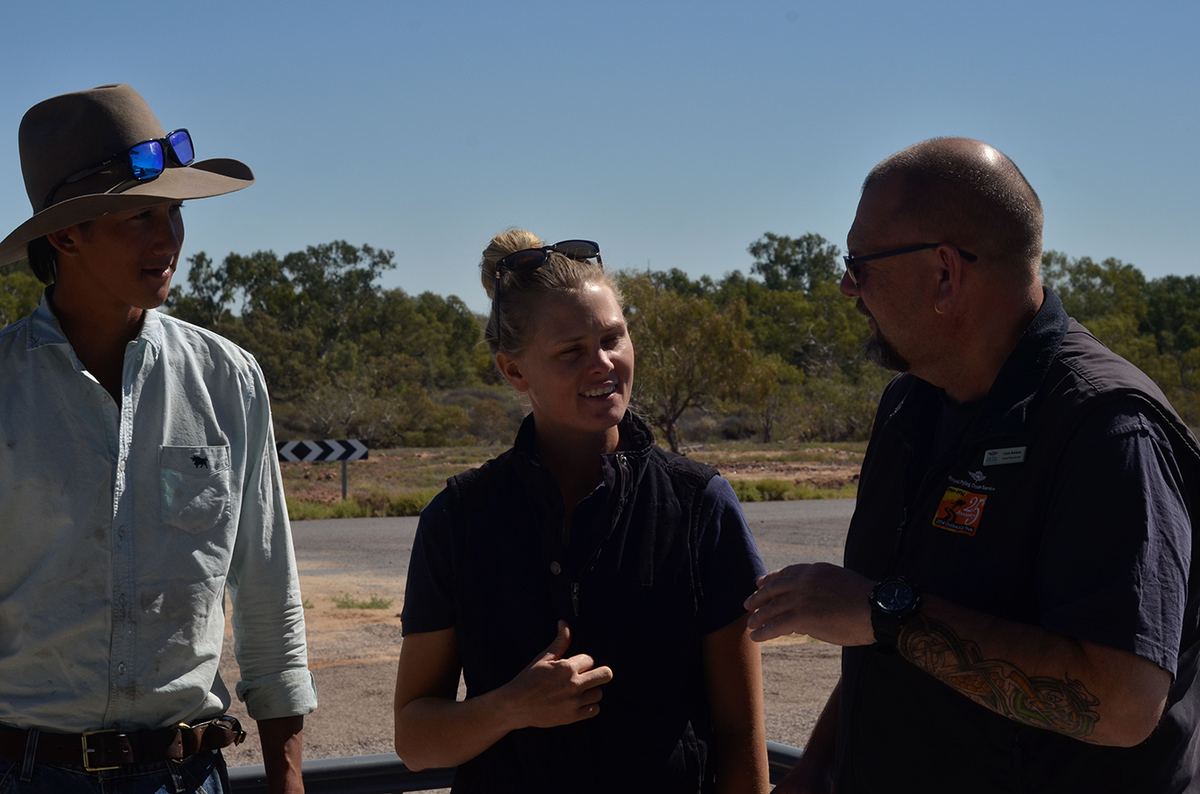 Innamincka station farm hand Josiah Bradley and stock manager Tegan Hall speak to Nurse Practitioner Chris Belshaw