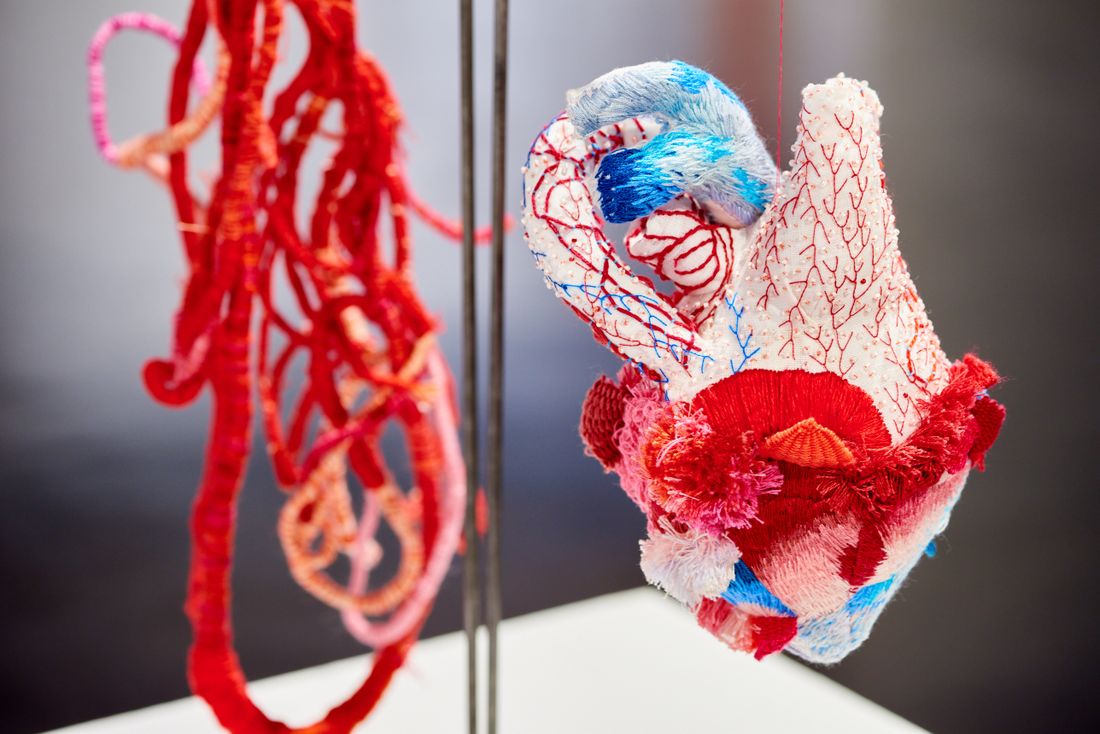 A close up of one of the embroidered heart soft sculptures