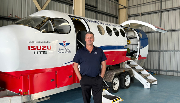 Stuart in front of aeromedical simulator
