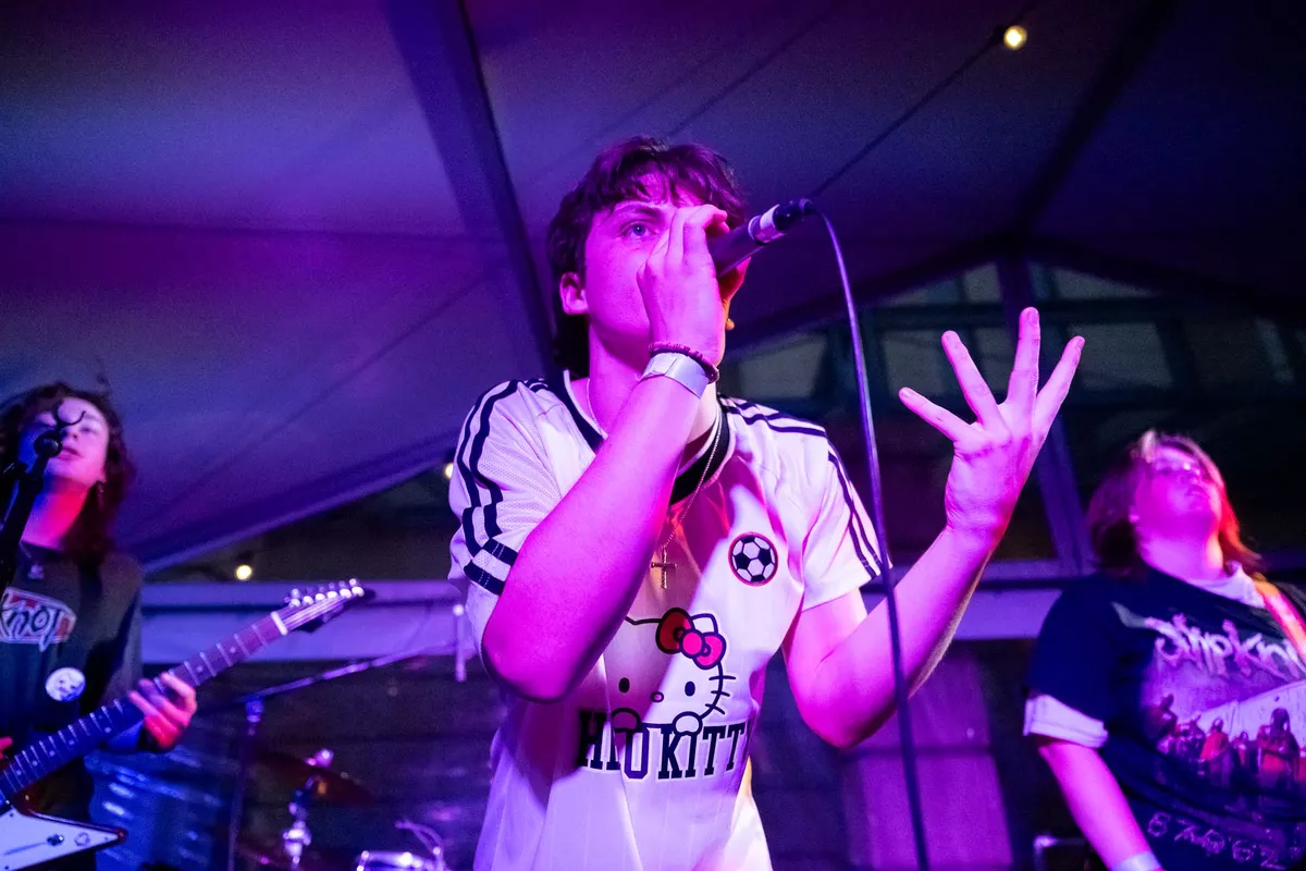 Young performer singing into microphone.