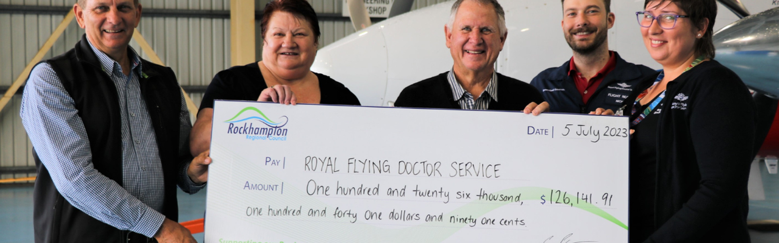 RFDS receiving cheque from Rockhampton Regional Council 