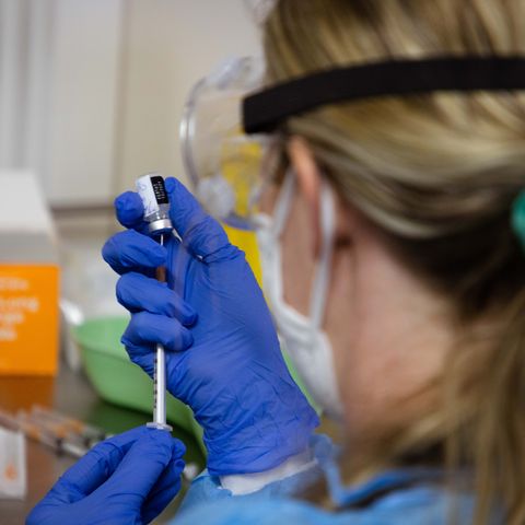 A health professional preparing a vaccine