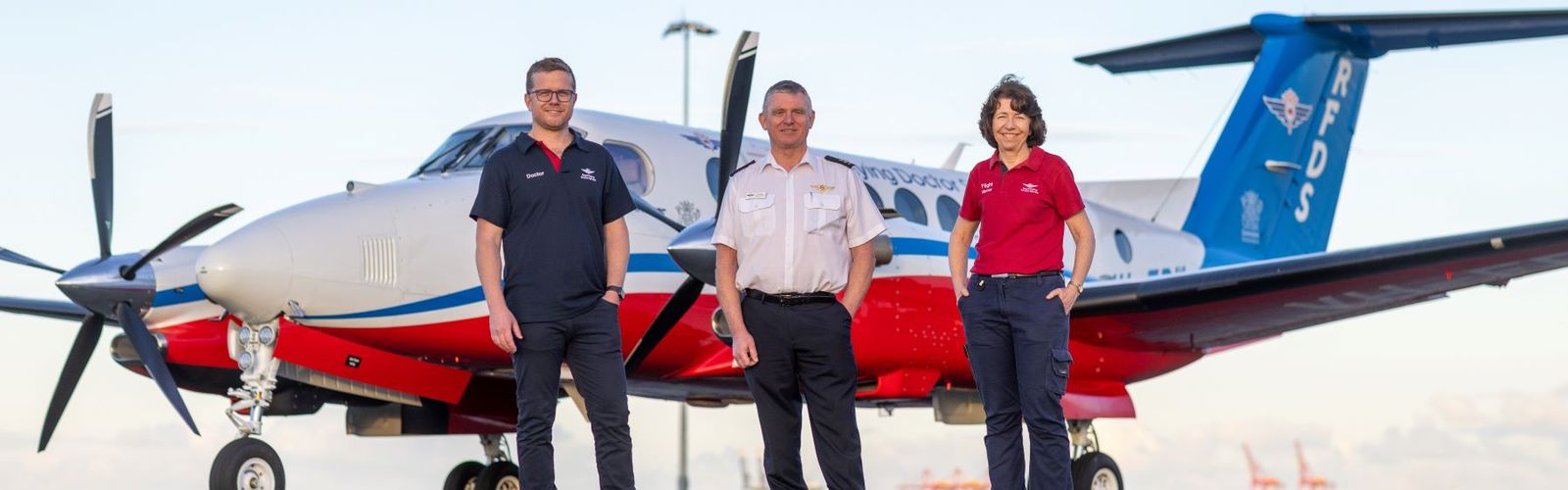 Doctor, Pilot, and Nurse stand in front of the B360 aircraft