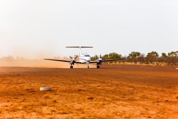 RFDS (Queensland Section) aircraft landing on dirt runway