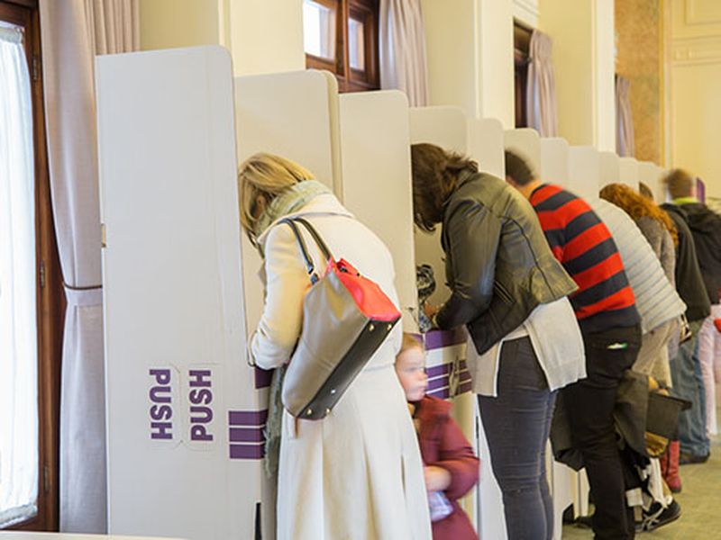 Photo of people voting in Australian Election cardboard booths