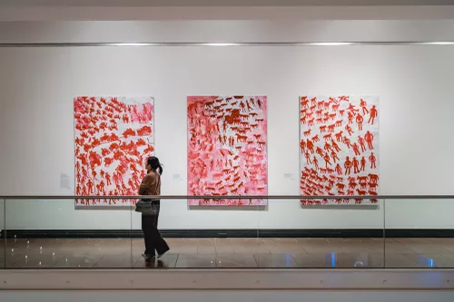 A person views a work of art in an exhibition