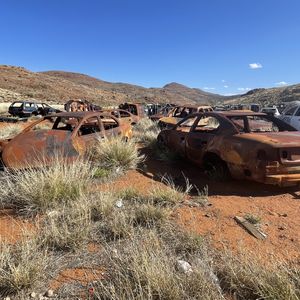 A landscape image of a rusty car graveyard at Putkatja on APY Lands