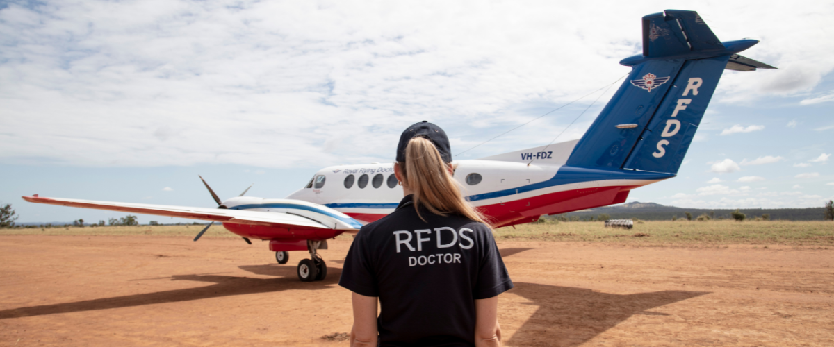Doctor in front of aircraft