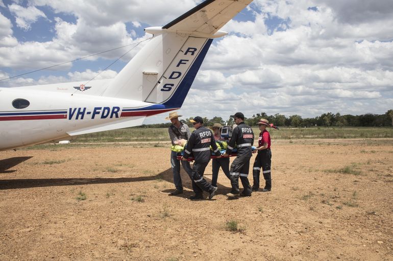 Flying Doctor Crew Carry a Patient to the Plane