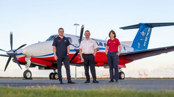 Doctor, Pilot, and Nurse stand in front of the B360 aircraft