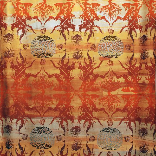 Detail of a piece of orange silk printed with a reflective pattern of brain coral and bristlecone pine