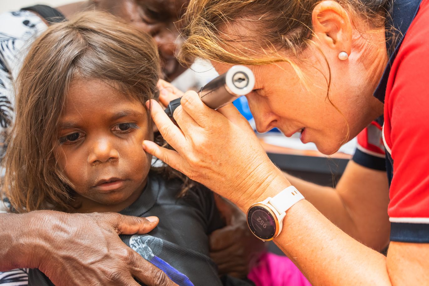 Nurse Lisa looking at a patients ear in the Yakanarra clinic.