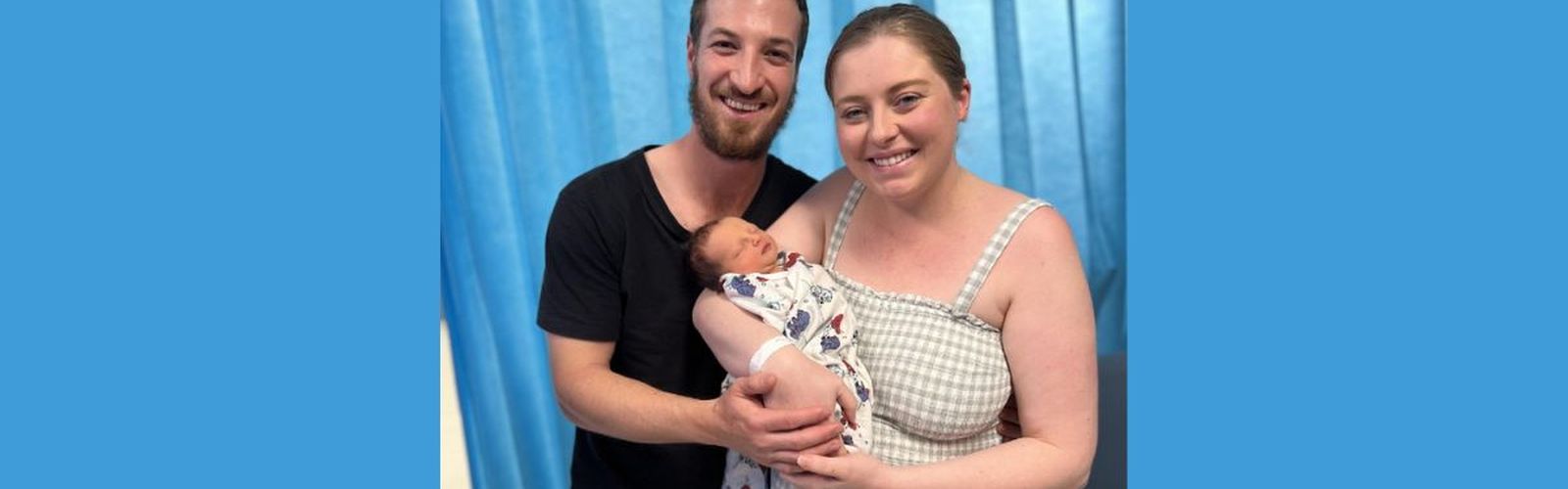 Liam and Hannah are pictured holding their newborn baby, Harry.