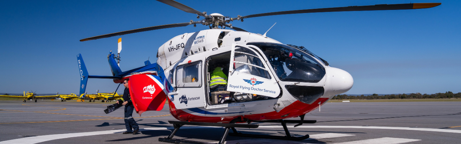 RFDS team member giving an activity book to a young boy