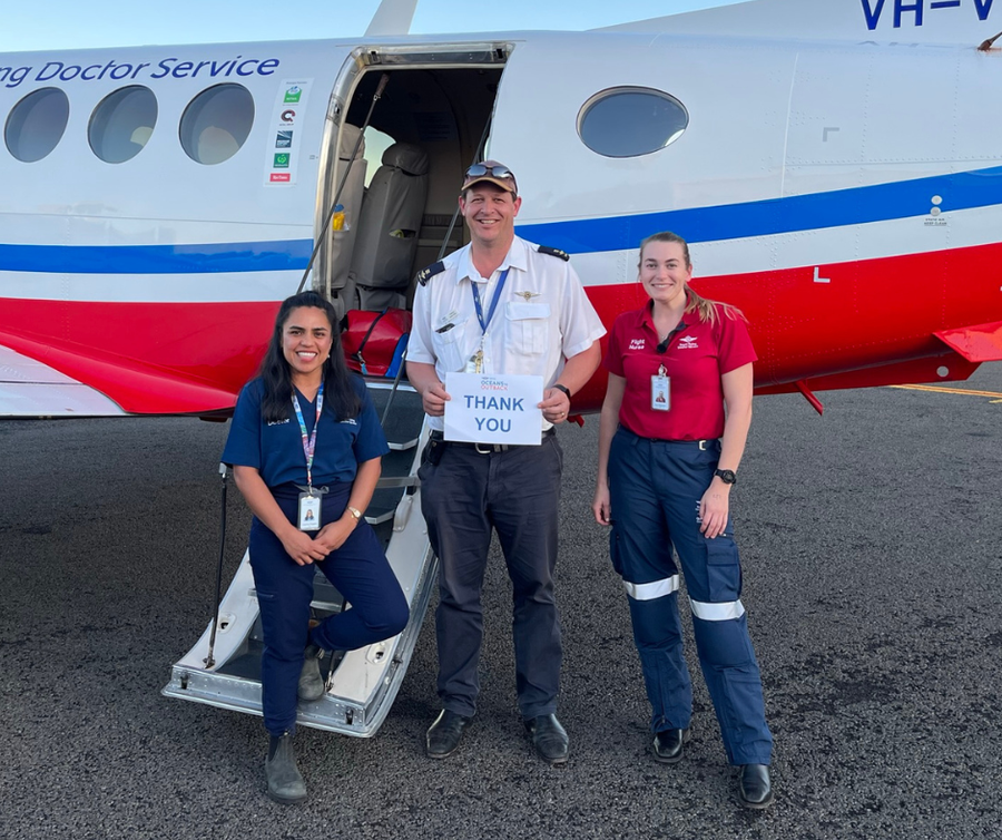 Izzy and the team in front of aircraft