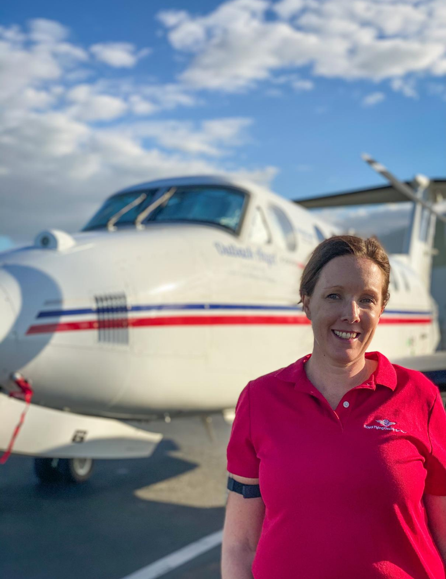 Elizabeth Ferrier standing in front of an RFDS plane