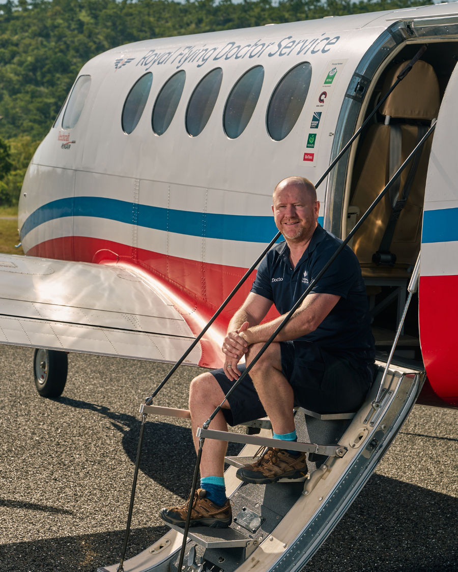 Dr sitting on aircraft stairs